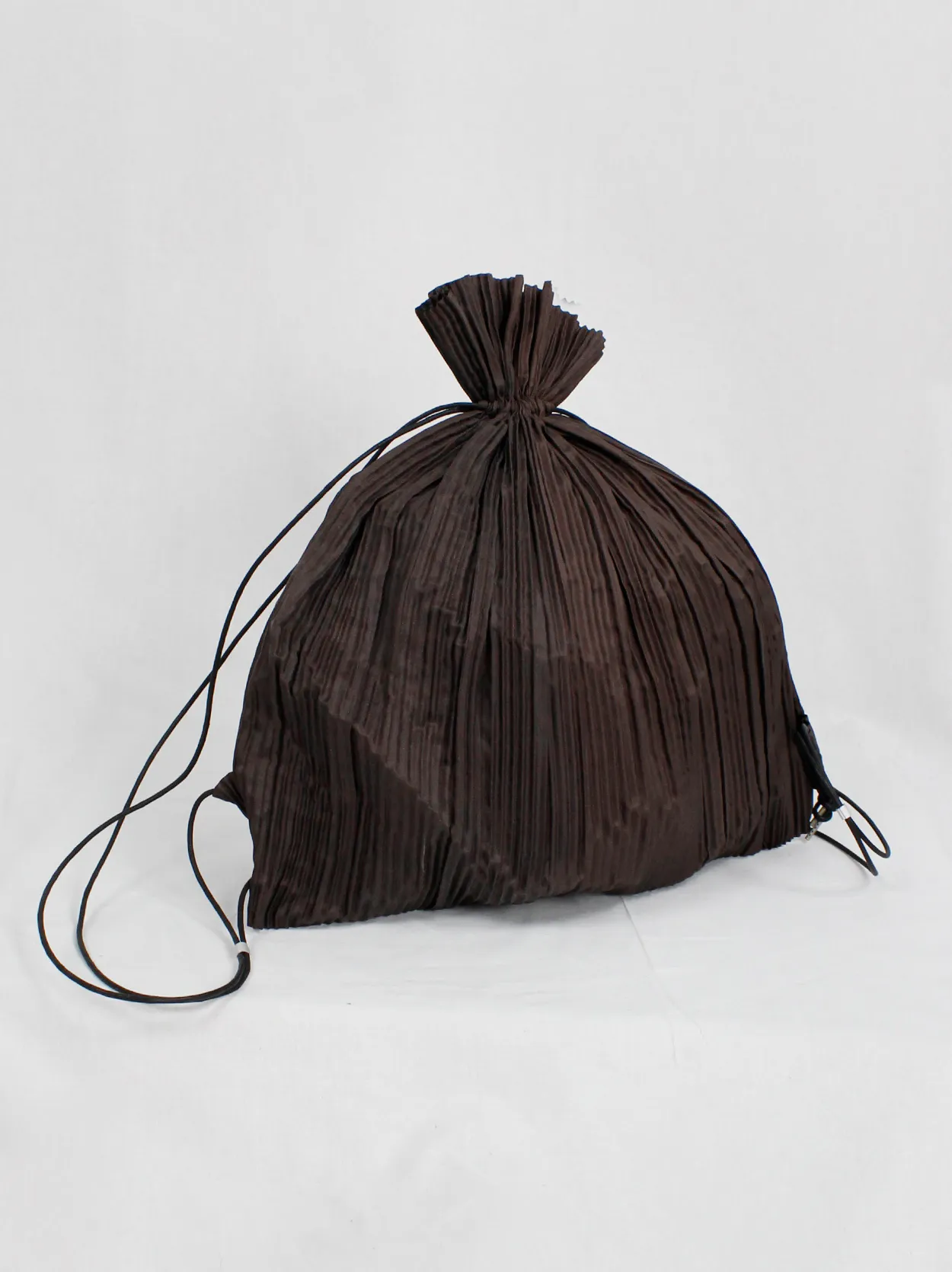Issey Miyake dark brown drawstring backpack with fine pressed pleats