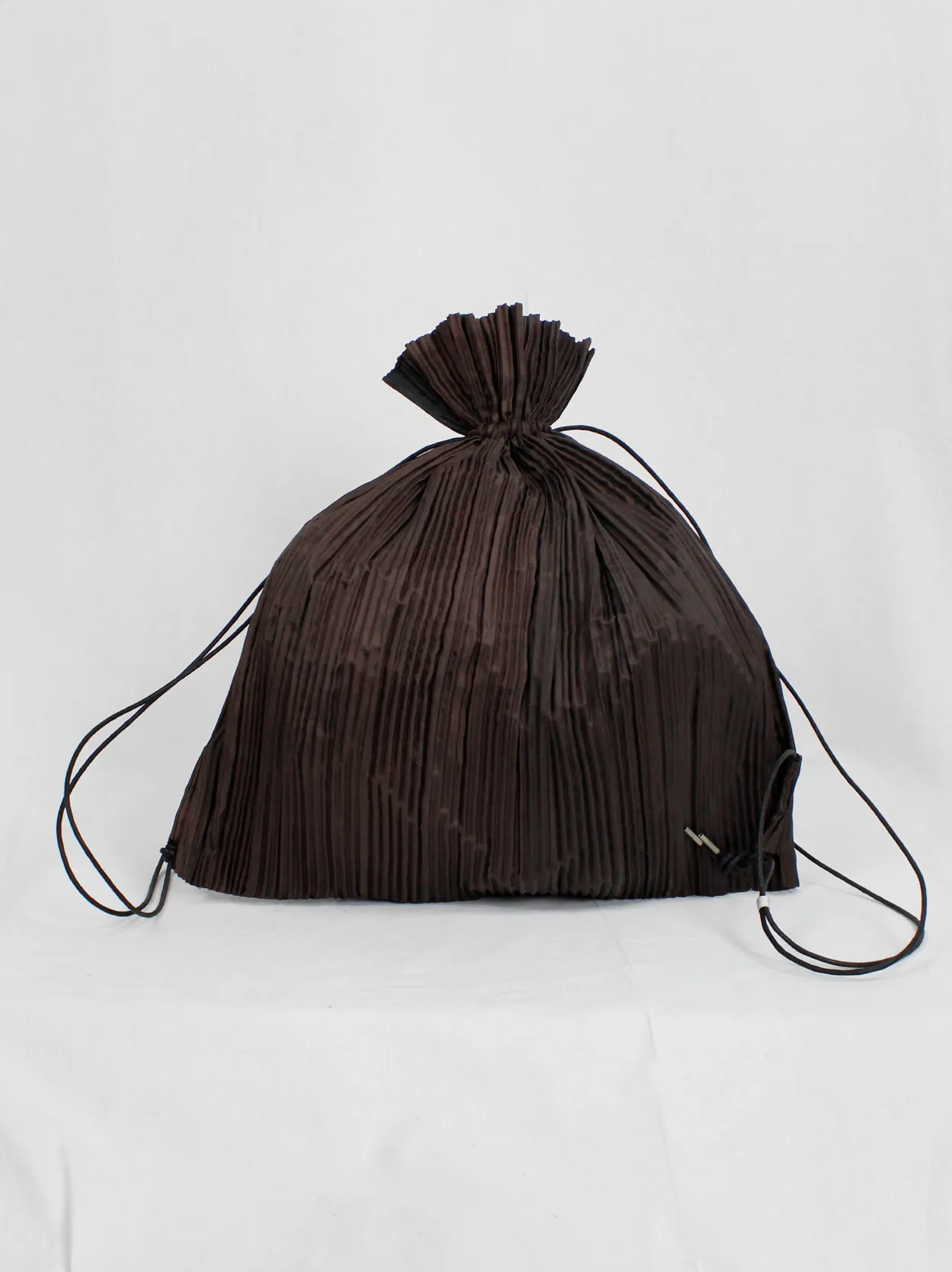 Issey Miyake dark brown drawstring backpack with fine pressed pleats
